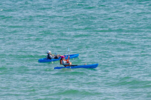 Activities at sea in front of Encantame. Kayaking couple